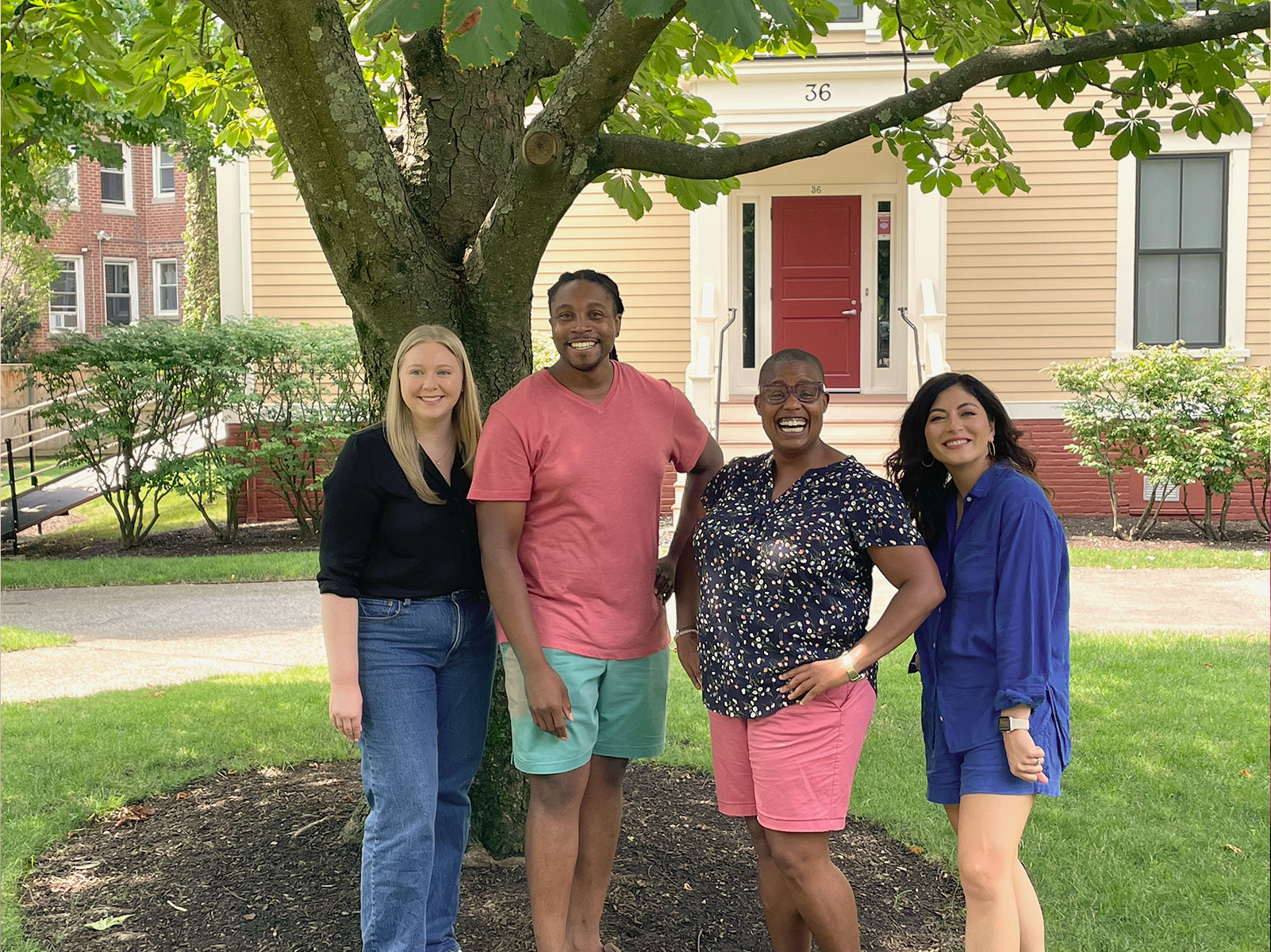 Four of the Crimson Summer Academy staff members smile while posing for a photo.